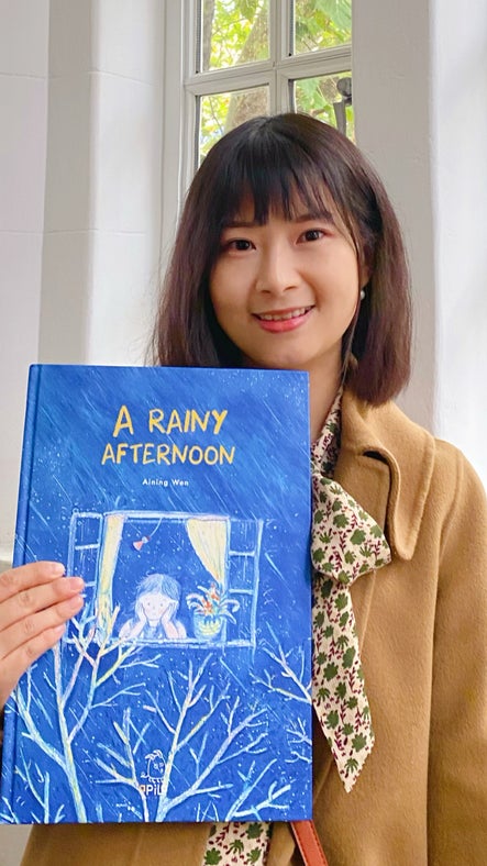 Writer Aining Wen and one of her illustrated children's books